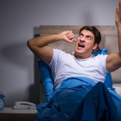 man cannot sleep because of noisy neighbour